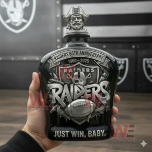 Black Raiders anniversary whiskey bottle with pirate stopper silver logo football graphics and bold team slogan held by a person indoors!
