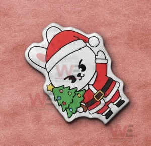 Cartoon rabbit shaped pillow in santa outfit on a pink fabric background!