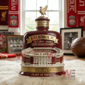 Red commemorative whiskey bottle with stadium design and golden bird topper placed in a football themed room!