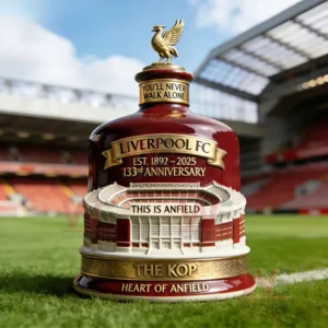 Red commemorative whiskey bottle with stadium artwork displayed on grass inside a football stadium!