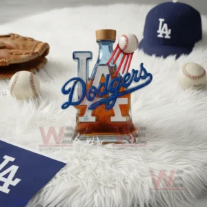 A Dodgers logo bottle with a flying baseball detail rests on a fluffy white rug with baseball items arranged around it!