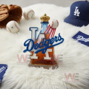 A crown topped Dodgers bottle with a soaring baseball detail stands on a soft white rug surrounded by baseball gear!