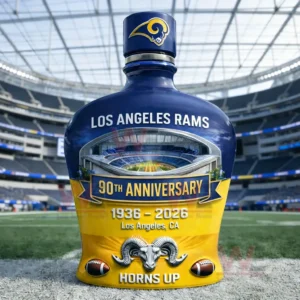 Blue and yellow Los Angeles Rams commemorative bottle with ninetieth anniversary details displayed on a football field inside a stadium!