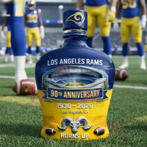 Los Angeles Rams Horns Up 90th Anniversary 1936-2026 Whiskey Bottle 5 Los Angeles Rams 90th anniversary blue and gold whiskey bottle with stadium illustration ram head emblem and Horns Up text shown on grass with players in the background!