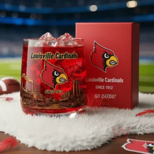 A close view of a Louisville Cardinals glass with red drink and skyline artwork displayed beside its matching red box in a sports arena setting!