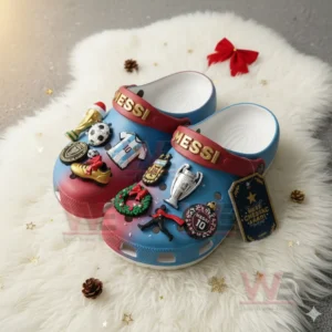 Messi decorated clogs filled with football and Christmas charms set on a white furry surface!