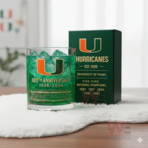 Miami Hurricanes 100th Anniversary 1926-2026 Whiskey Glass 4 Miami Hurricanes glass with green iced drink beside a dark green box in a softly decorated room!