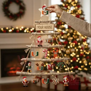 A rustic wooden wall tree decorated with miami hurricanes themed ornaments and warm string lights in a festive living room setting.