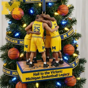 Four Michigan Wolverines basketball figures in yellow uniforms stand in a unified huddle on a display base with a basketball themed Christmas tree behind them!