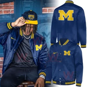Michigan Wolverines football Classic Logo Jacket 4 Model wearing blue Michigan jacket with yellow M logo and striped trim.