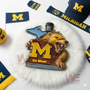 Wolverine shaped glass bottle with M logo and Go Blue text placed on white fur with Michigan themed accessories around!