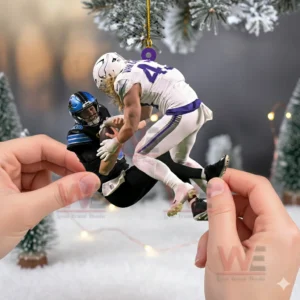 Hands holding a football tackle ornament hanging from a decorated Christmas tree in a winter setting!