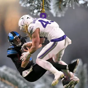 Football tackle ornament hanging from a Christmas tree branch with winter background!