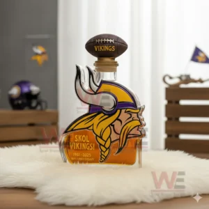 A Viking mascot shaped bottle with a football cap on a white fur mat with helmet and flag in the background.