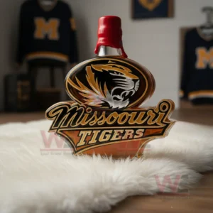 Missouri Tigers custom whiskey bottle with tiger logo and amber liquid standing on a white fur rug with sports decor behind it!