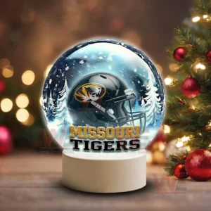 Holiday themed snow globe with Missouri Tigers helmet on a white base near Christmas decorations!