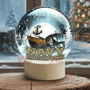 A snow globe with a white team helmet sits on a wooden surface with snowy trees visible outside the window!