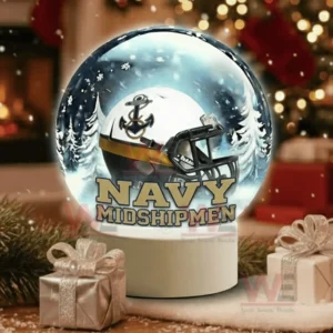 A snow globe with a white team helmet sits on a wooden table surrounded by holiday gifts and decorations!