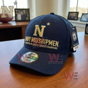 Navy Midshipmen championship cap resting on a wooden desk in an office environment!