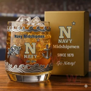 A Navy Midshipmen branded drinking glass filled with ice and amber liquid positioned next to a gold box displaying matching Navy graphics and lettering!