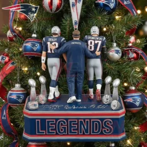 Two Patriots player figures and a coach figure stand arm in arm on a display base surrounded by a Christmas tree decorated with team ornaments and lights!