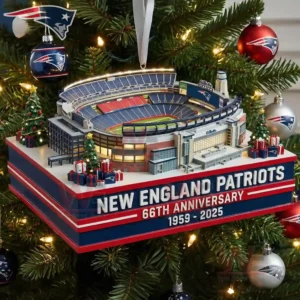 Miniature New England Patriots stadium ornament hanging on a Christmas tree with red blue and silver team decorations and warm holiday lights!