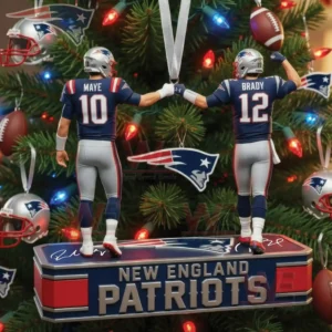 Two Patriots uniformed players numbered ten and twelve fist bumping on a team themed ornament in a decorated Christmas tree!