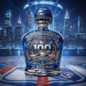 New York Rangers 1926-2026 100Th Anniversary We Bleed Blue Whiskey Bottle 3 A blue anniversary whiskey bottle with hockey helmet top displayed on ice with a night city skyline and glowing arena lights!