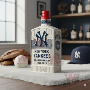 A themed Yankees whiskey bottle with pinstripes and logo standing on a white rug next to a baseball glove and ball in a softly lit room.