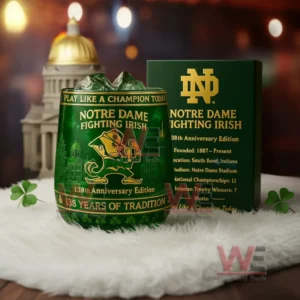 Notre Dame Fighting Irish anniversary glass with green iced drink beside a dark green box showing team logo and historical information!