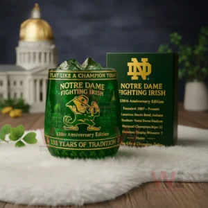 Notre Dame Fighting Irish 138 Years Of Tradition Whiskey Glass 3 Notre Dame Fighting Irish anniversary glass with green iced drink beside a dark green box in a setting with university inspired decor!