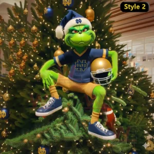 A green figure wearing a blue outfit sits on a brightly lit Christmas tree decorated with gold and blue ornaments.