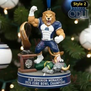 Old Dominion Monarchs lion mascot ornament celebrating beside a Cure Bowl trophy pedestal on a champions base hanging on a Christmas tree.