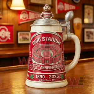 A close view of a decorative Ohio Stadium anniversary beer stein placed on a wooden counter surrounded by warm ambient decor!