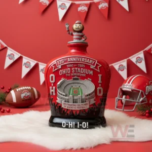 Red anniversary glass bottle with Ohio Stadium design and mascot topper placed on white fur with football decorations and red background!