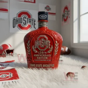 A red Ohio State anniversary bottle standing on a rug with helmets and team banners in the room!