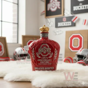 A gold crowned Ohio State bottle standing on a rug surrounded by team decorations!