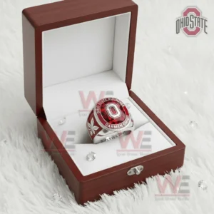 Ohio State Buckeyes ring in an open wooden box with white interior featuring a red gemstone style top block O logo Ohio State Buckeyes Carmen Ohio text and small decorative crystals on a soft white background!