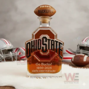 Ohio State Buckeyes Go Bucks 1980-2025 135th Anniversary Custom Whiskey Bottle 4 An Ohio State bottle with a football cap on white fur surrounded by helmets and a football.