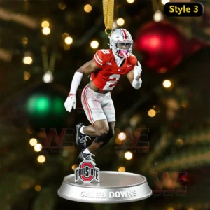 Ornament of Caleb Downs in action on a base with a Christmas tree background!