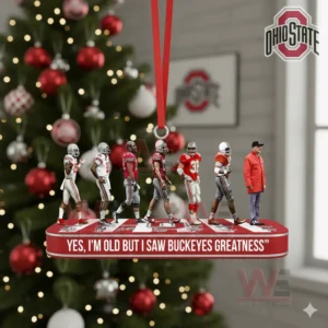 A row of Ohio State Buckeyes figures on a red platform hanging in front of a festive Christmas tree!
