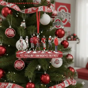 Buckeyes figures on a red platform ornament hanging on a decorated Christmas tree in a holiday themed room!