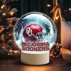 Snow globe style display featuring an Oklahoma Sooners helmet on a white base in a winter scene!