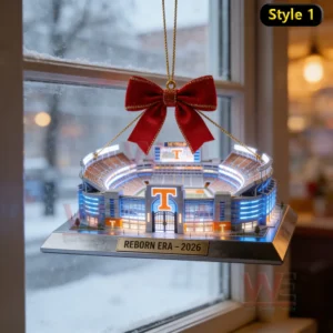 Miniature football stadium Christmas ornament with red bow hanging in front of a snowy window scene!