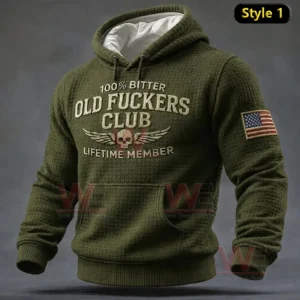 Olive green hoodie with large vintage text and winged skull emblem on the chest and a USA flag patch on the sleeve!