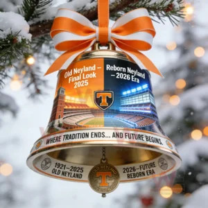 Football stadium bell ornament with orange bow hanging on a snowy tree branch during winter!