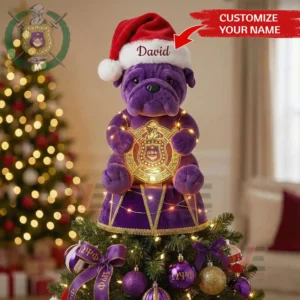 Purple bulldog plush in Santa hat holding glowing Omega Psi Phi emblem used as a Christmas tree topper with matching ornaments!