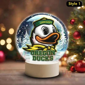 Illuminated glass sphere with Oregon Ducks mascot against a snowy background on a white base!