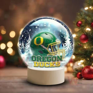 Snow globe style display featuring an Oregon Ducks helmet on a white base in a winter scene!