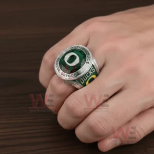 Oregon Ducks Eugene Oregon Go Ducks Ring 5 Hand wearing Oregon Ducks ring with green gemstone face and raised O emblem.